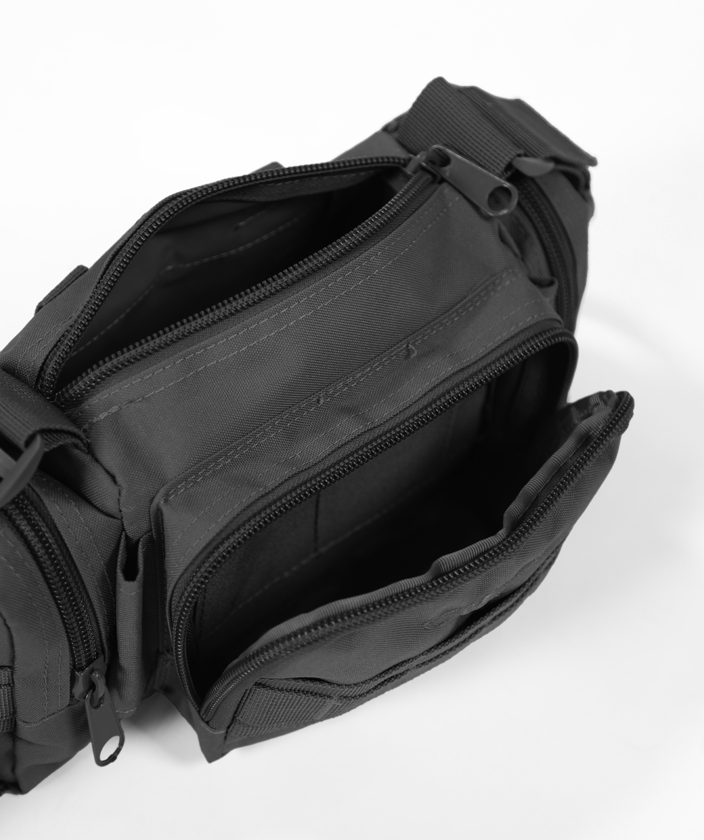 close up view for  black duffel bag open  with multiple zippered compartments and an adjustable shoulder strap