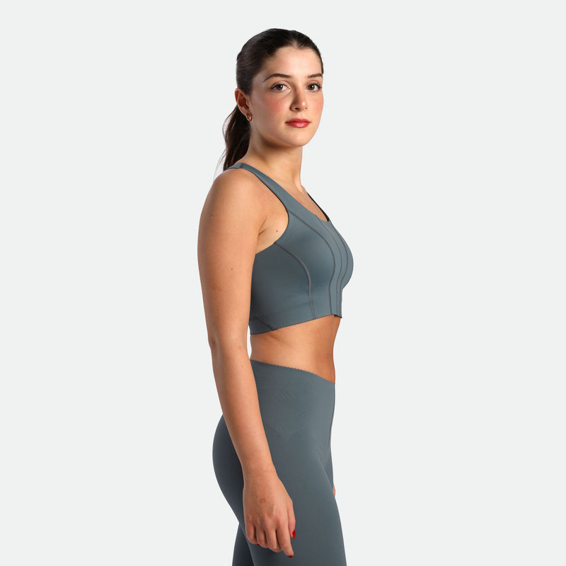 a fit woman stand at right and wearing matching set stormy grey ,bra and legging 