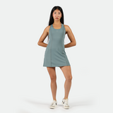 a fit woman wearing  dress green with sneakers 