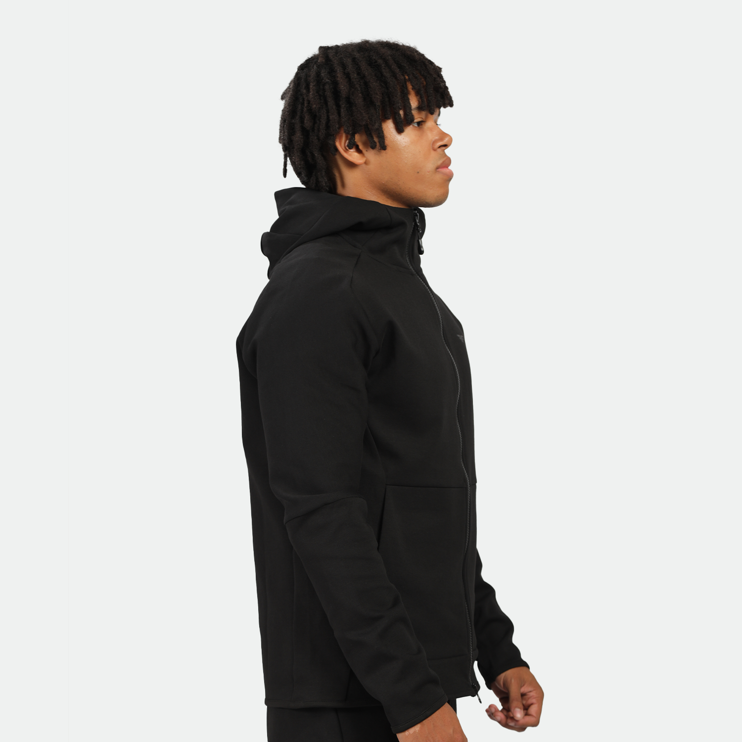 a fit man stand at right and wearing tech zipped hoodie black  with pants 