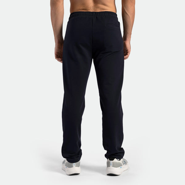 a back view for fit man wearing pants black with shoes 