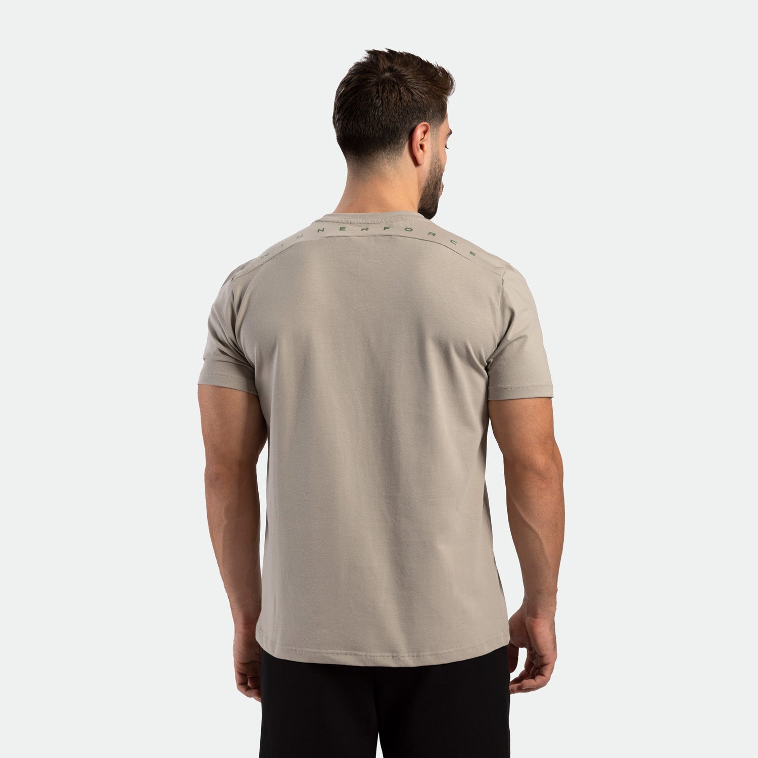 a back view for fit man wearing t-shirt AGATE-GREY with pants black 