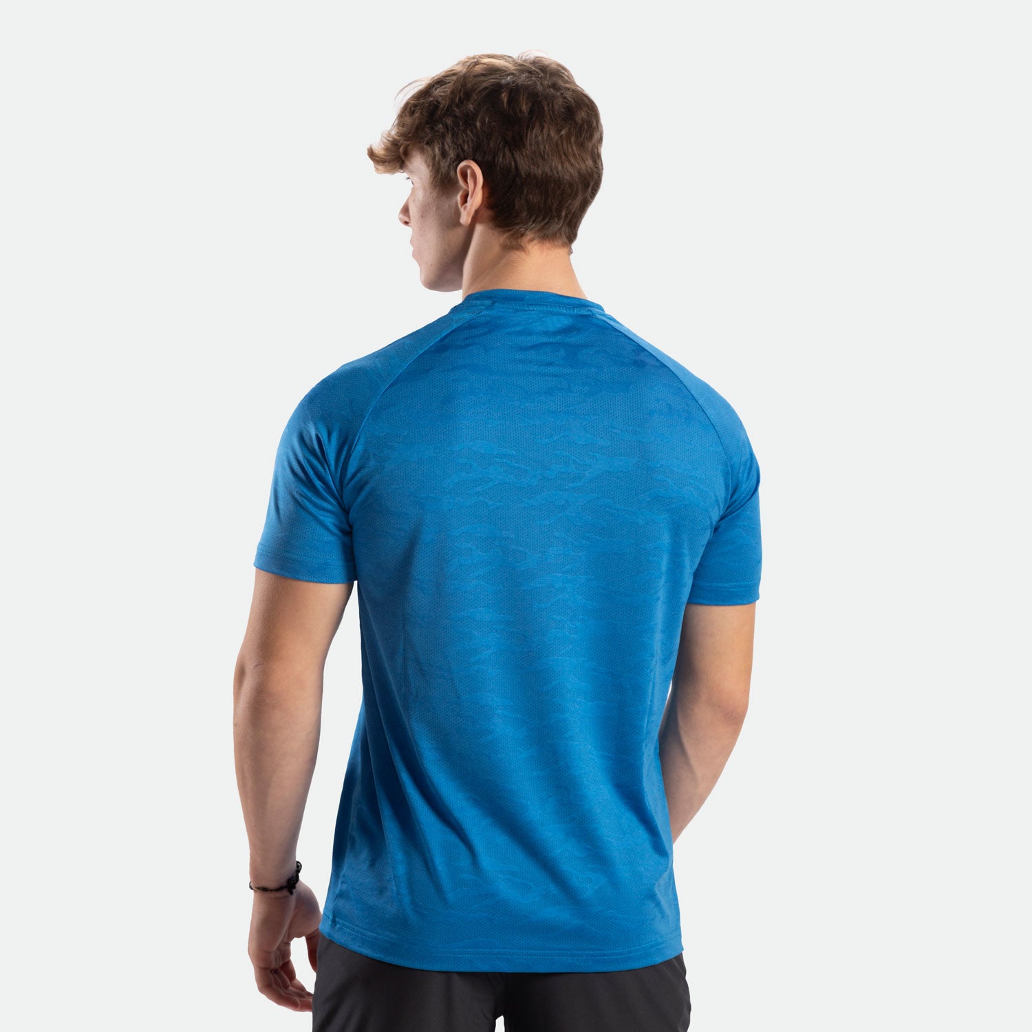 a back view  for fit man wearing camo  t-shirt azure blue with pants black 