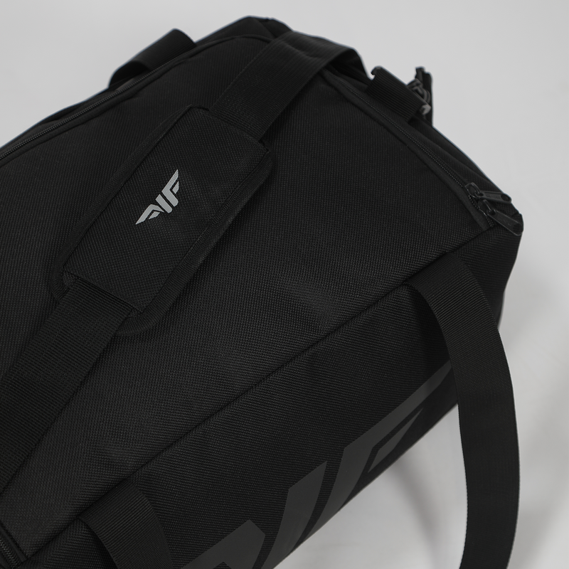 A sleek black duffel bag with two sturdy handles and a subtle embossed logo. Set against a light background, the bag exudes a modern, minimalist vibe.