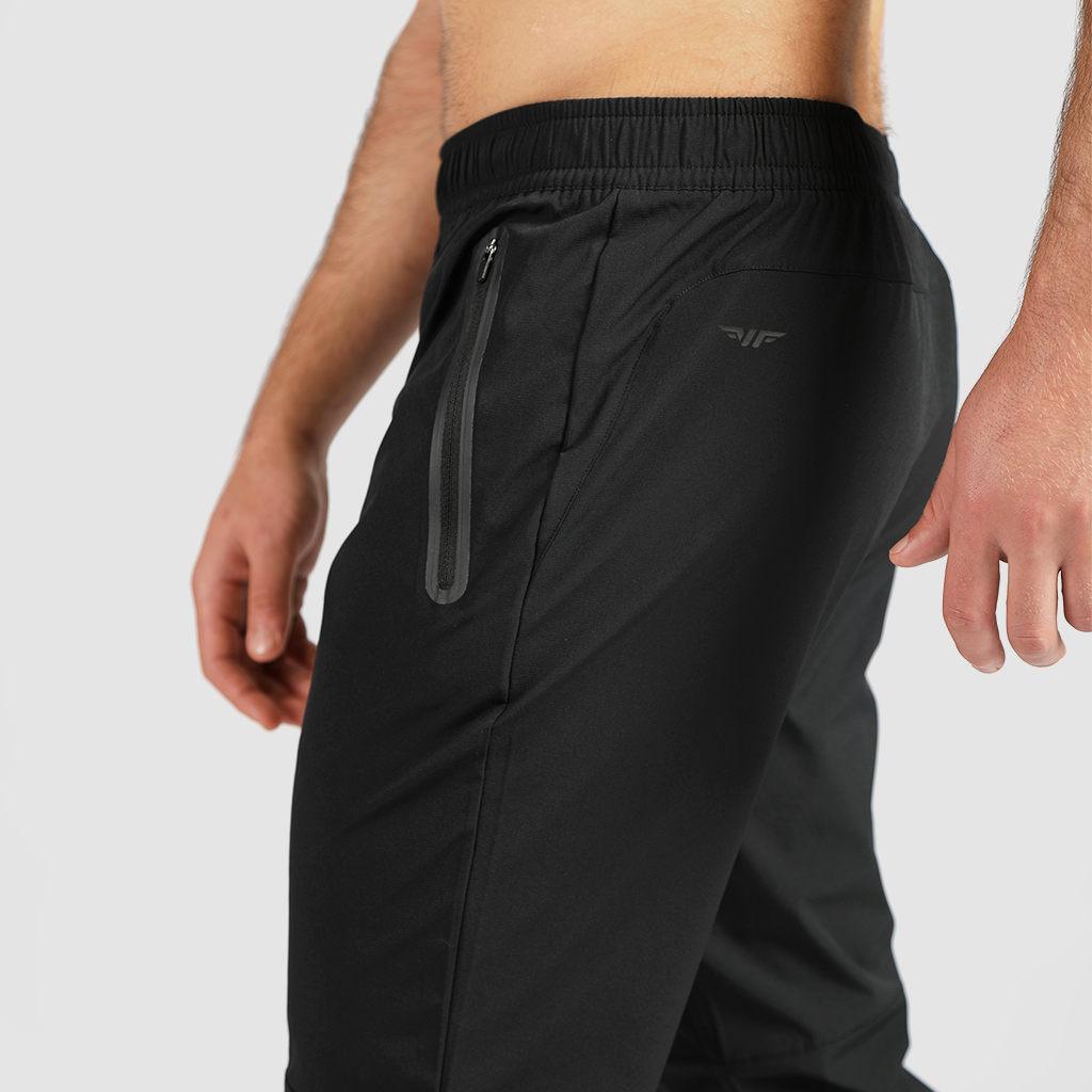 close up view for fit man stand at right and wearing pants black 