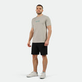 a fit man wearing t-shirt grey with short black ,plus the shoes white 
