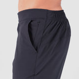 a fit man stand at right and wearing  pants black  with pocket black and zipper 