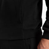 close up view for tow pocket of matching set black ,hoodie and pants 