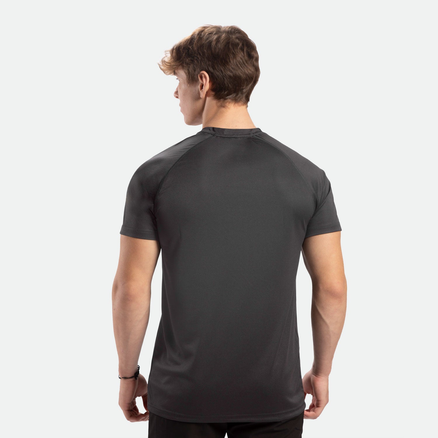 a back view for fit man wearing t-shirt dark grey ,plus the pants black 