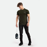a fit man wearing t-shirt dark olive with logo and pants black ,plus shoes 