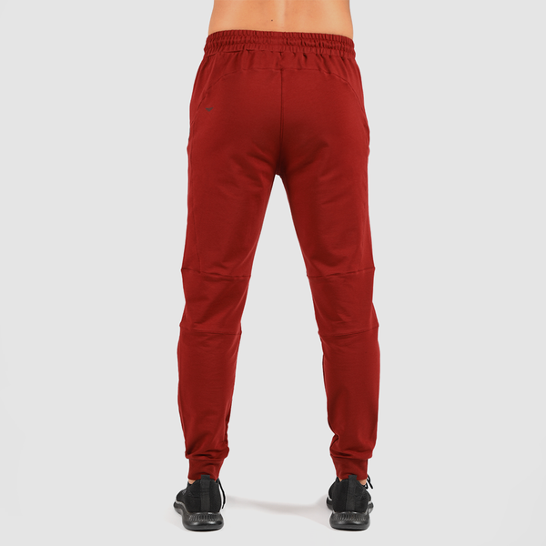 a back view for fit man wearing pants dark red with shoes black 