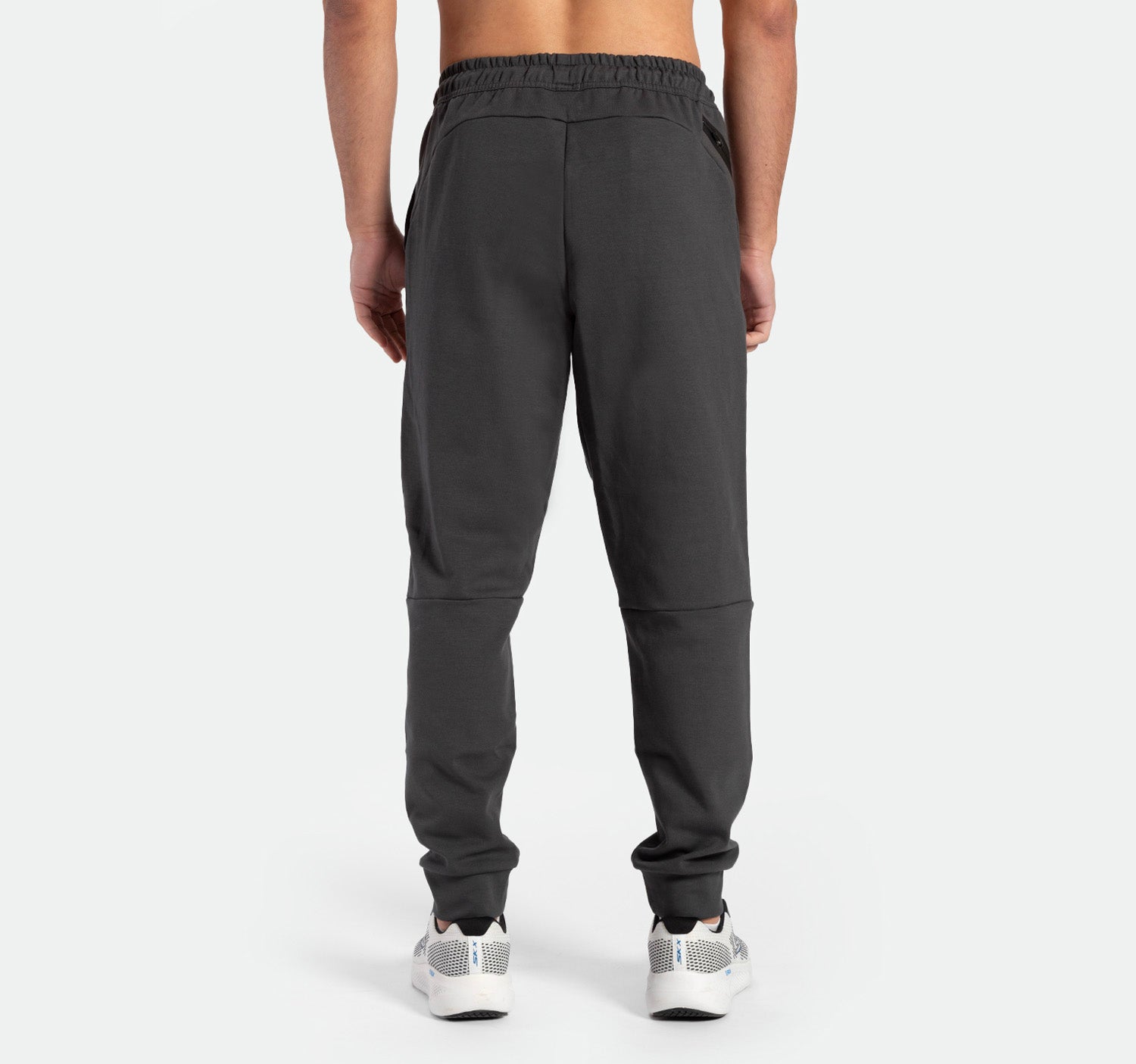 a back view for fit man wearing  pants grey ebony with shoes sports 