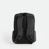 Back view of a  iron grey backpack featuring two adjustable padded shoulder straps, a padded back panel with breathable mesh, and a sturdy top handle