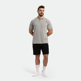 a fit man wearing t-shirt light grey with short black with socks white 