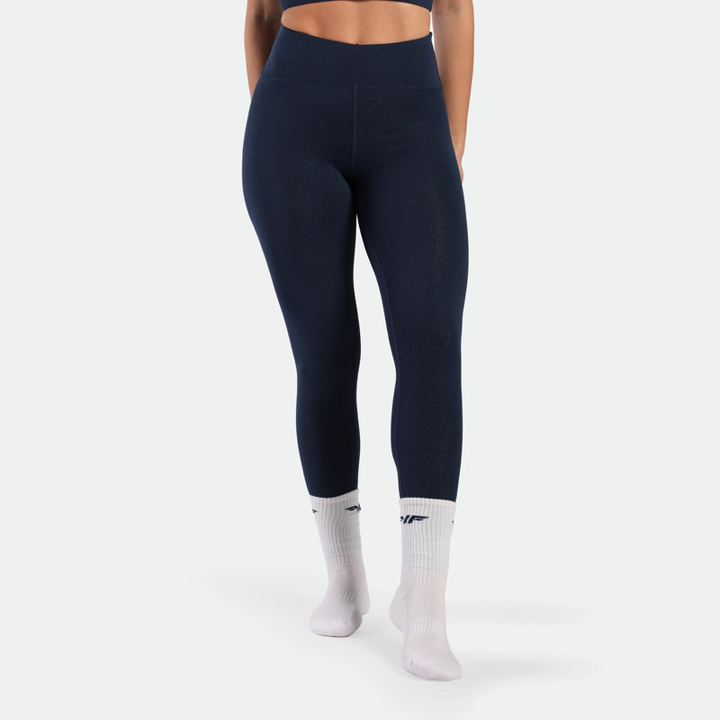 a fit woman wearing legging navy blue terrazzo with socks white 
