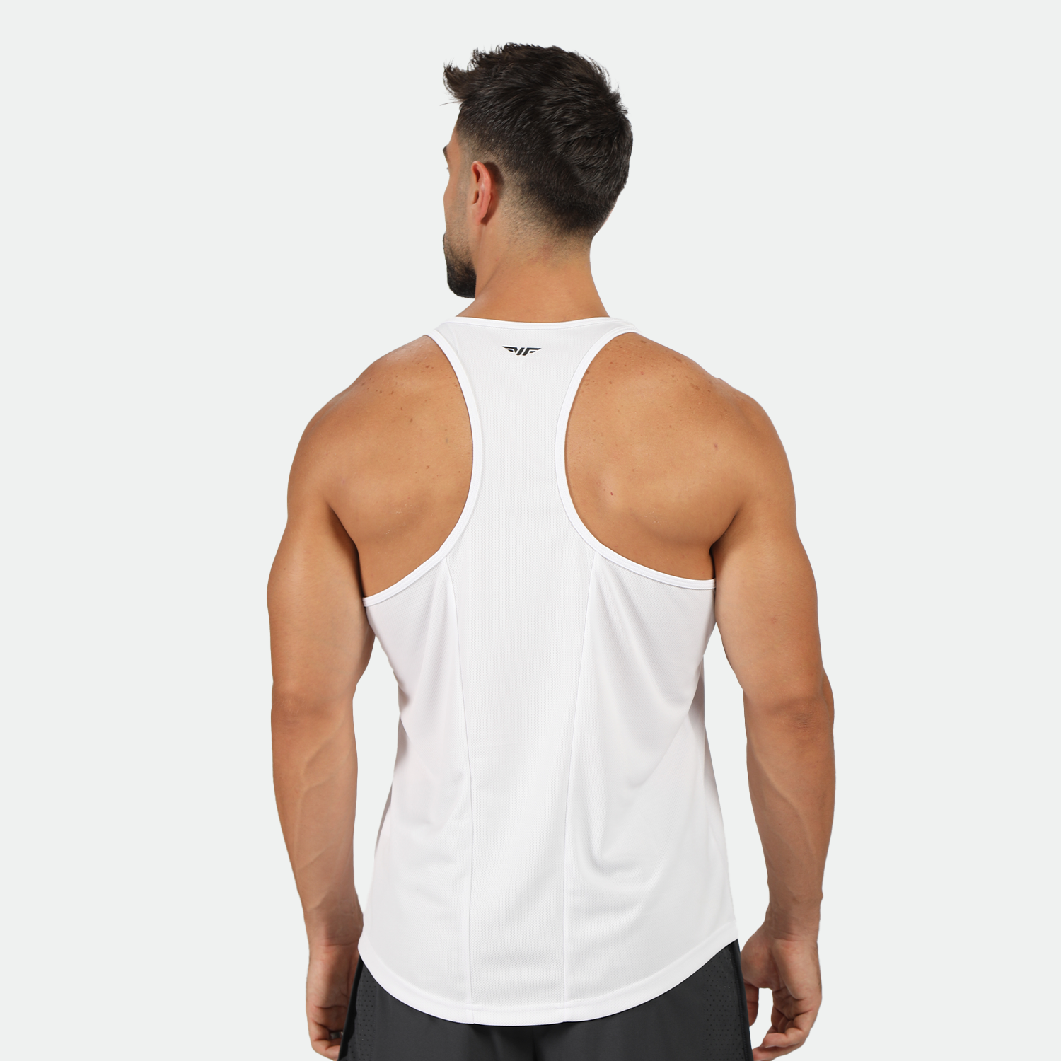 a back view for fit man wearing tank white with short 2 in 1 black 