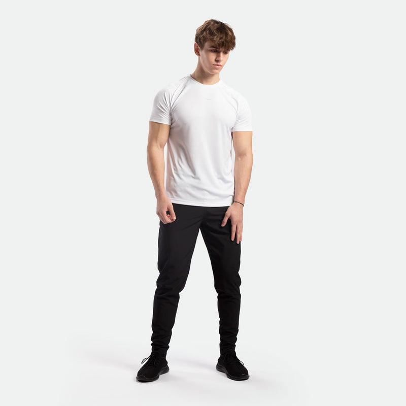 a fit man wearing camo  t-shirt white with pants and shoes black 