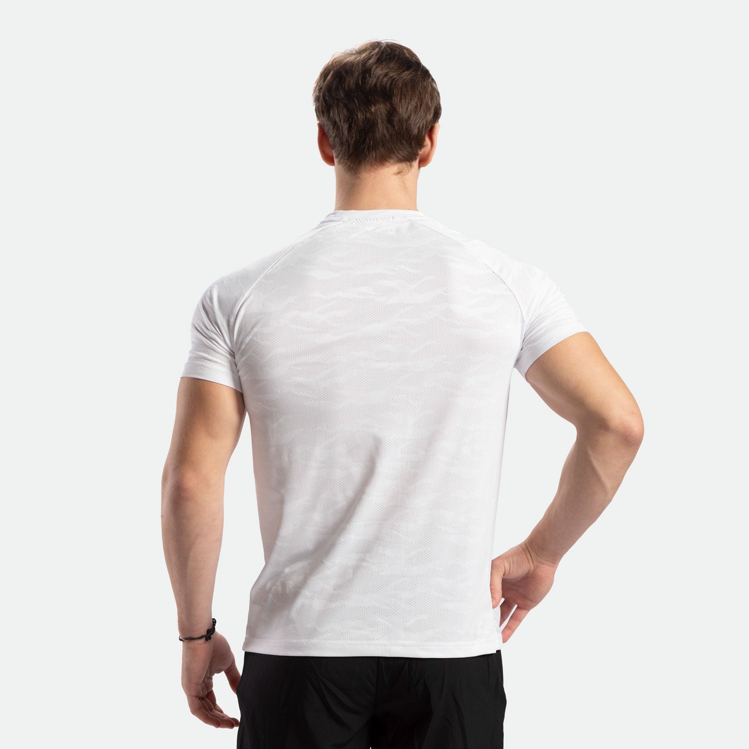 a back view for man wearing t-shirt white camo with pants black 