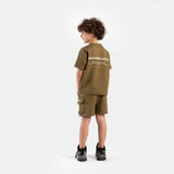 a back view for boy wearing matching set olive drop ,t-shirt with logo and short with tow pocket ,plus shoes  