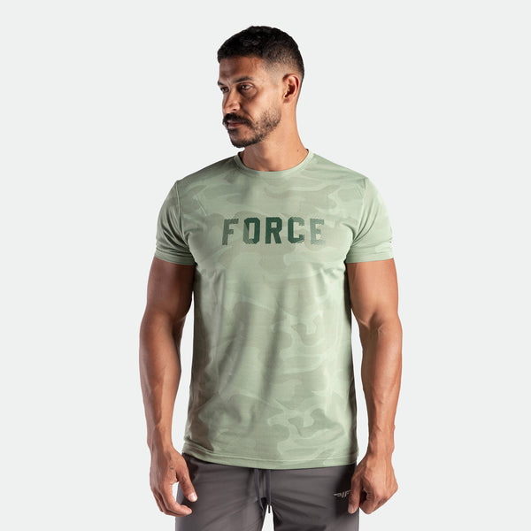 a man wearing t-shirt camo green bay with logo and pants grey 