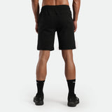 a back view for fit man wearing short black , plus the socks and shoes black 