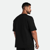 a back view for man wearing matching set black ,t-shirt and short 