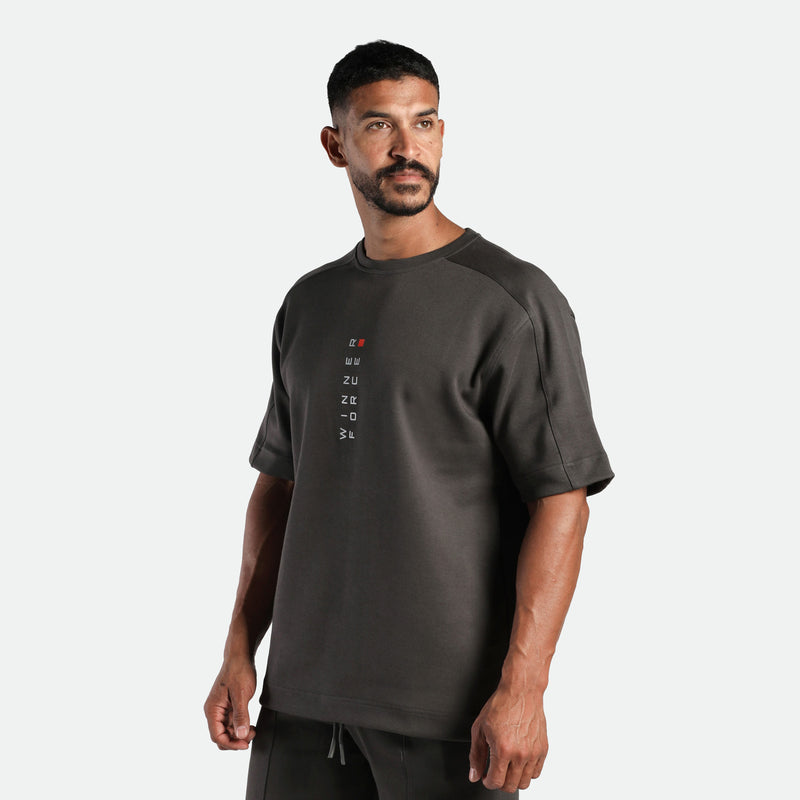 a fit man wearing matching set iron dark grey , t-shirt with logo and short 