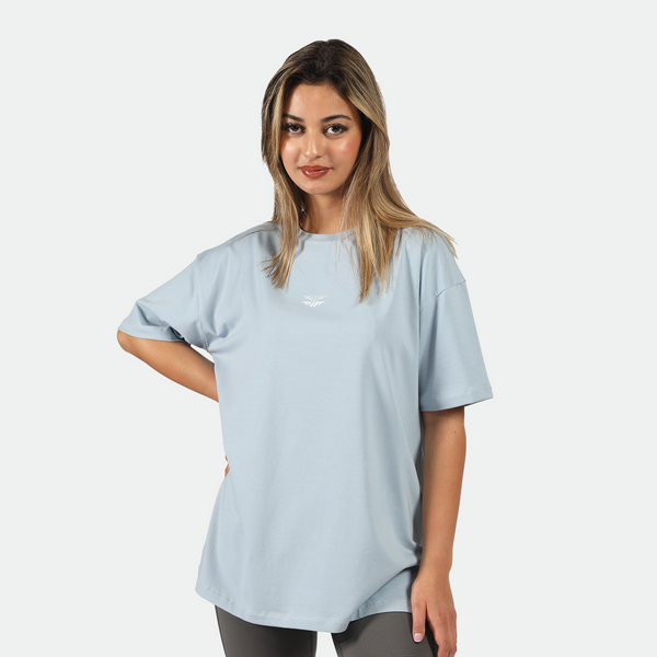 a fit woman stand with pose  and wearing t-shirt blue  with logo and legging grey 