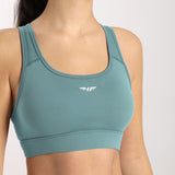 Woman wearing a bra with a split logo (winnerforce), the color of the bra is blue 