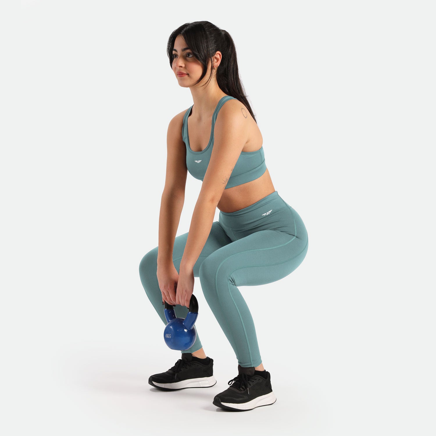  Young girl in squatting position, wearing bra and leggings, it includes winnerforce logo with different directions 