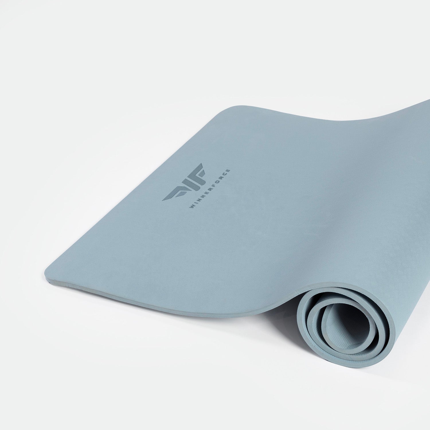 A rolled up chambray blue training mat with a visible logo on the surface.