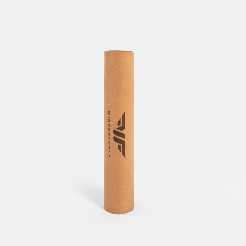Brown foam roller with "winnerforce " and a logo printed in black. Stands vertically on a light grey background, it is conveying simplicity and utility.