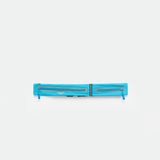A DRESDEN-BLUE, rectangular zippered pouch with two parallel reflective strips and zipper pulls, displayed against a plain white background