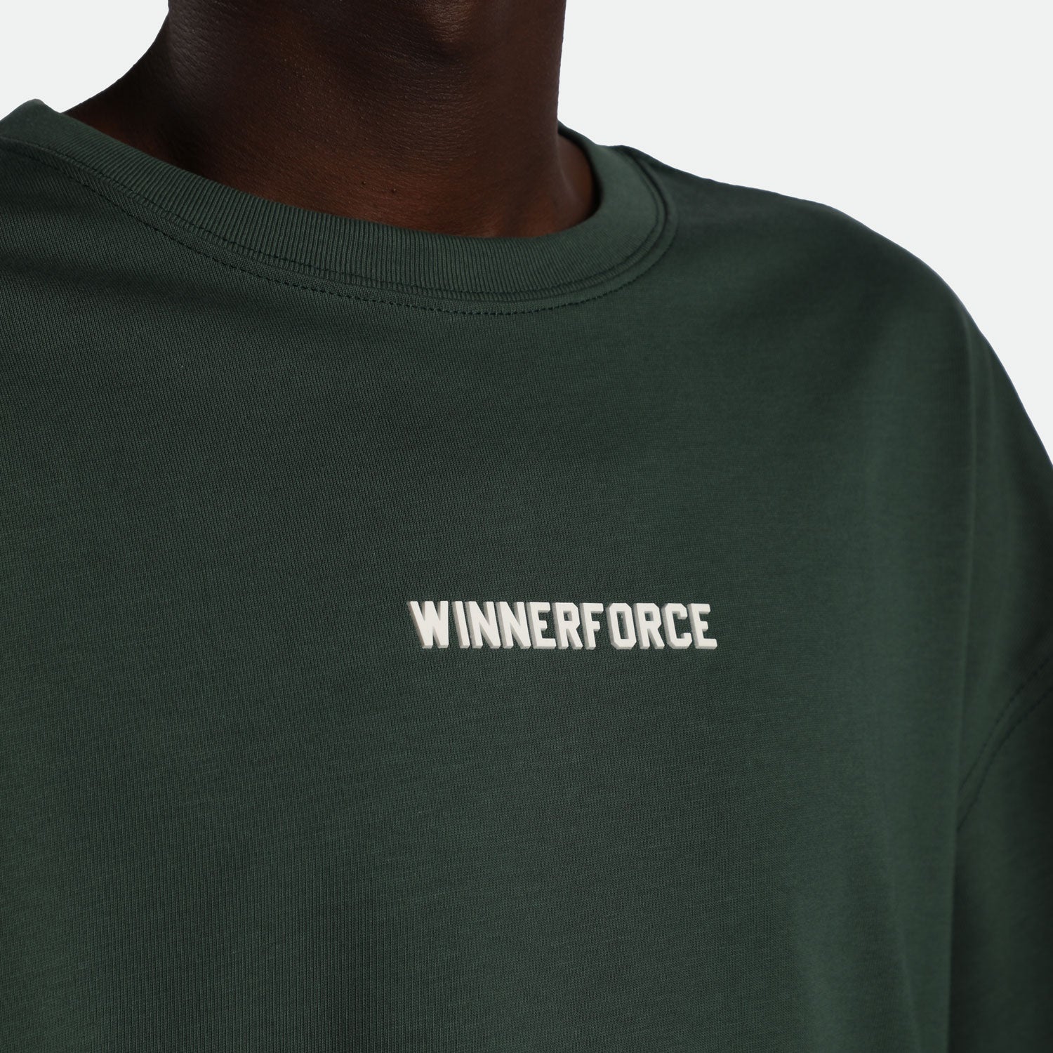  close up view for man wearing t-shirt green with logo white 