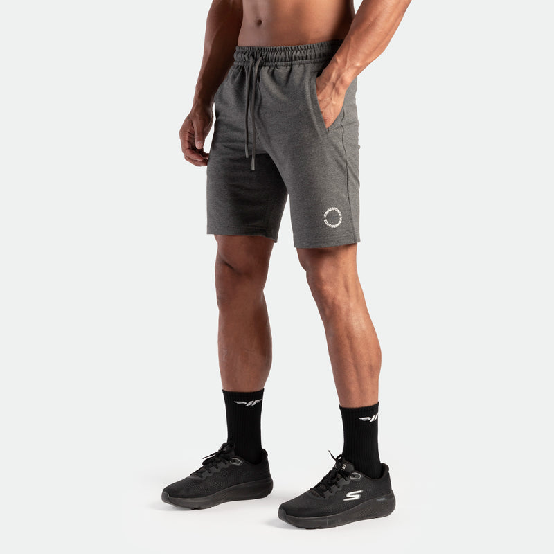 a fit man wearing  short marl ark grey with logo and lace ,plus the socks black with shoes 