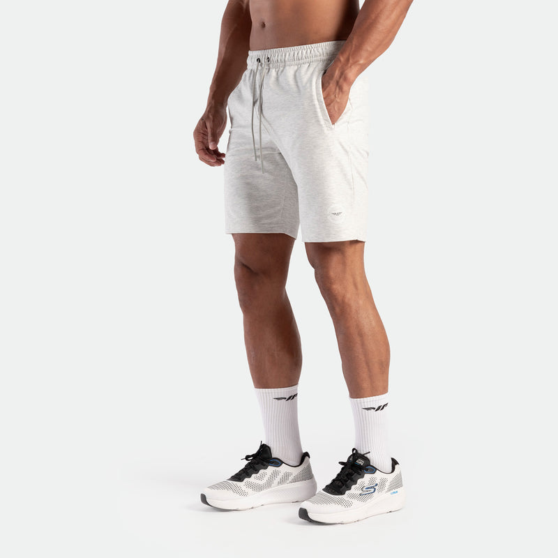 a fit man wearing short marl light grey with logo and lace ,plus socks white with shoes     
