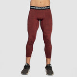 a fit man wearing base layer wine red with shoes 