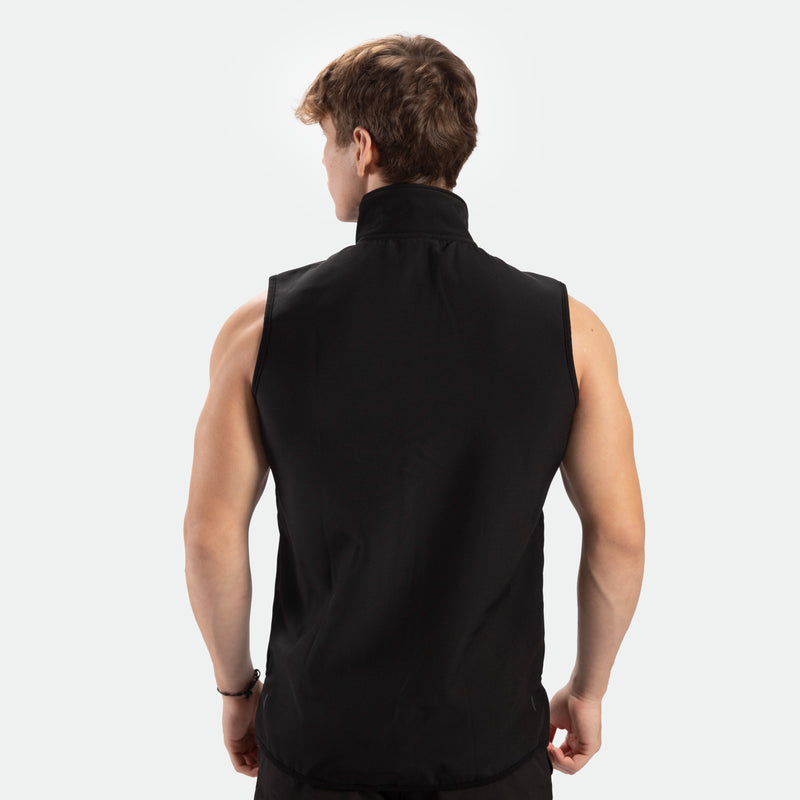 a back view for fit man wearing zip vest  black with pants black 