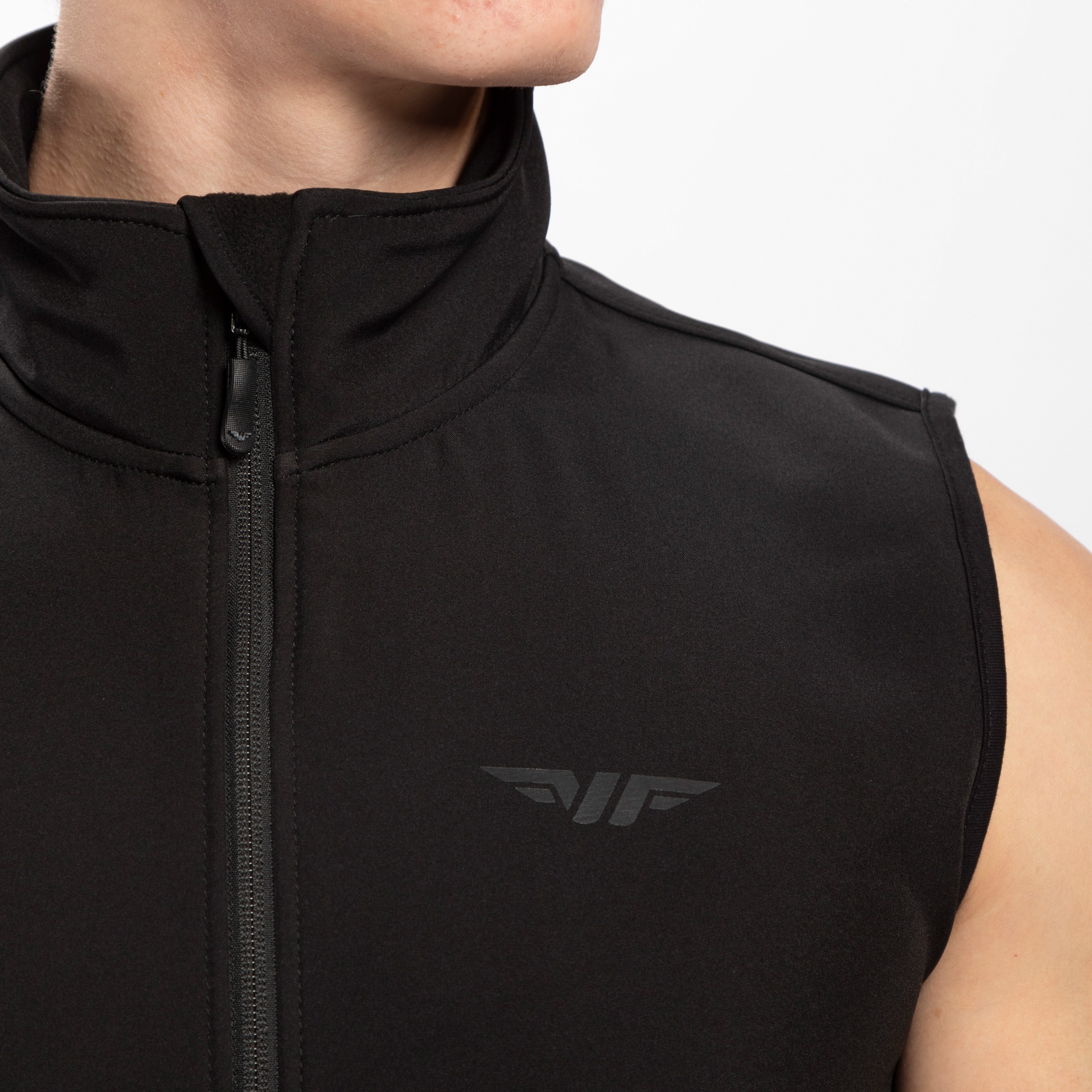 close up view for fit man wearing zip vest black with logo 