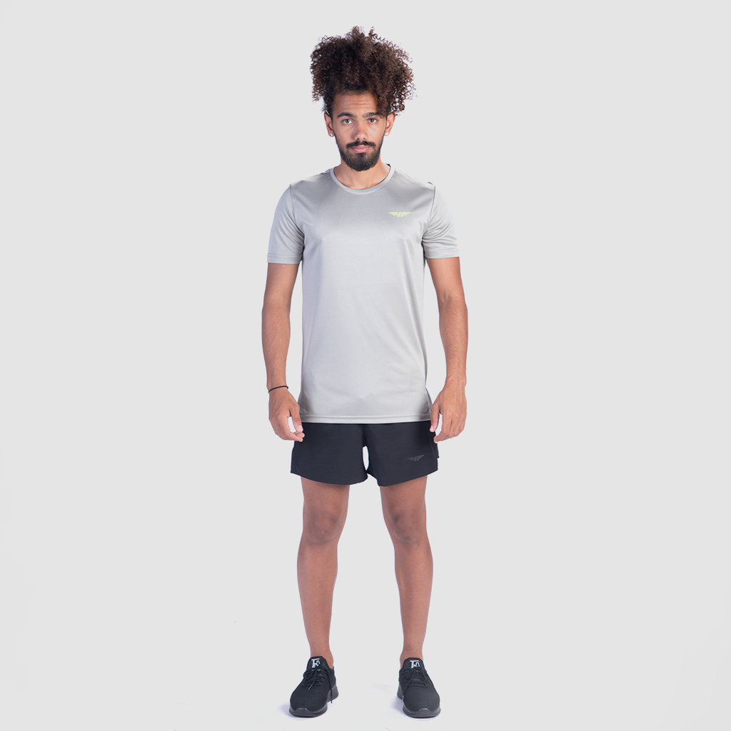 a fit man wearing t-shirt grey with short black  ,plus shoes  black 