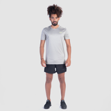 a fit man wearing t-shirt grey with short black  ,plus shoes  black 