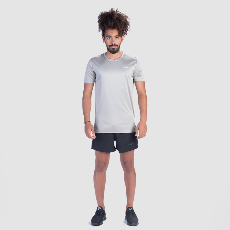 a fit man wearing t-shirt grey with short black  ,plus shoes  black 