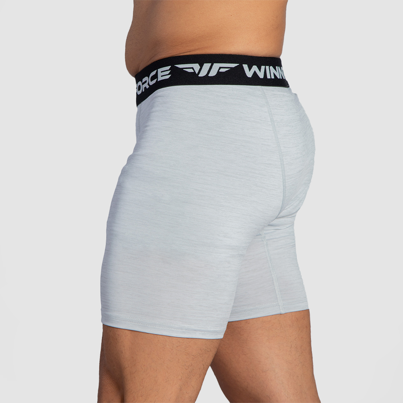 a fit man stand at right and wearing boxer marl white  with logo 