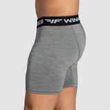 a fit man stand at right and wearing short steel grey 