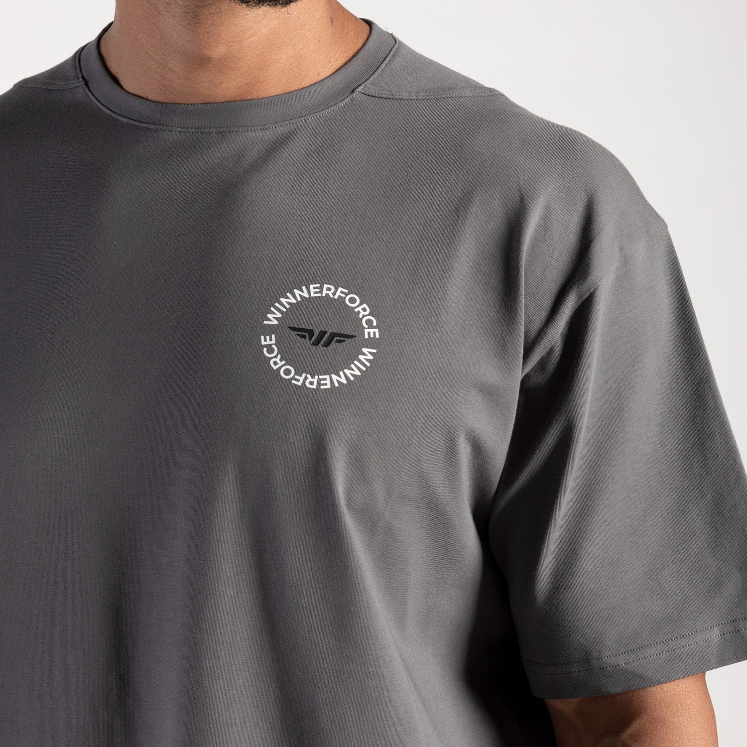 close up view for fit man wearing t-shit dark grey with logo 