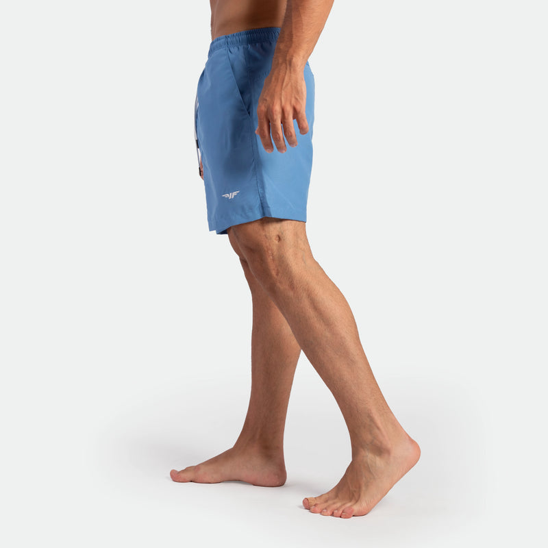 a fit man stand at right and wearing  short Marina blue 