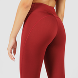 a back view for woman wearing legging red with background is light grey  
