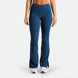 a fit woman wearing flared legging Poseidon blue with shoes white  