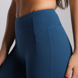 close up view for fit woman wearing flared legging Poseidon blue