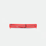 A TOMATO-RED, rectangular zippered pouch with two parallel reflective strips and zipper pulls, displayed against a plain white background